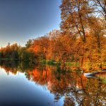 autumn-trees-over-a-pond-in-arkadia-park-in-poland-julis-simo